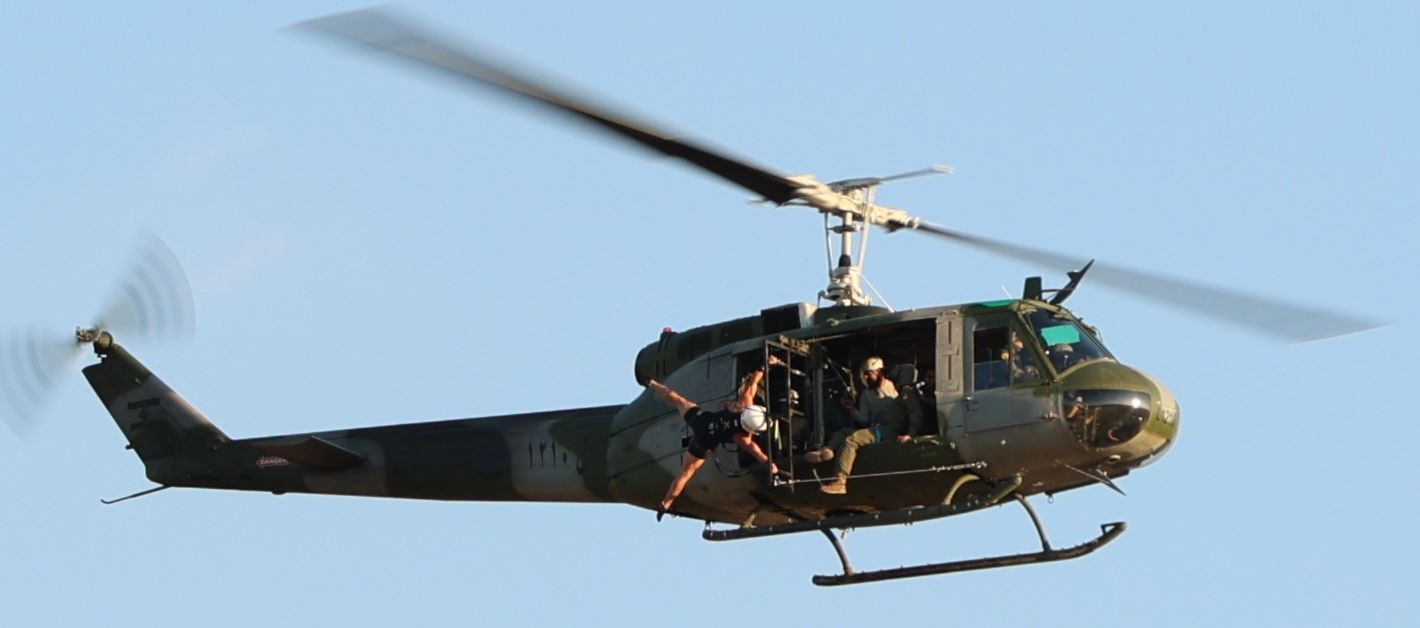 Samer Madi performing a straddle human flag from a flying helicopter