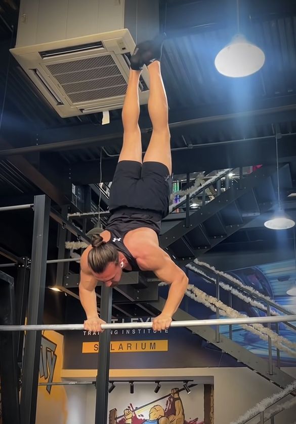 Samer performing an advanced handstand